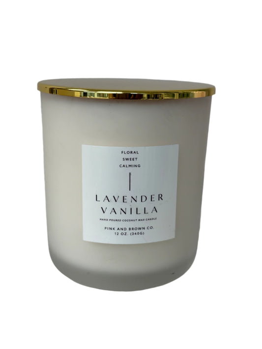 Candle with a gold lid and 'Lavender Vanilla' label on a white background